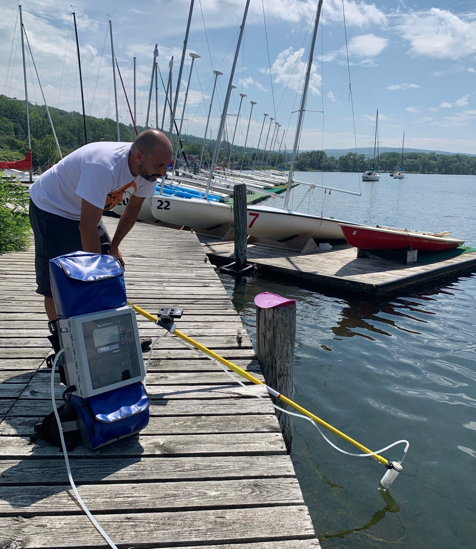 Jose Andres shown deploying water sampler on Cayuga Lake, NY.